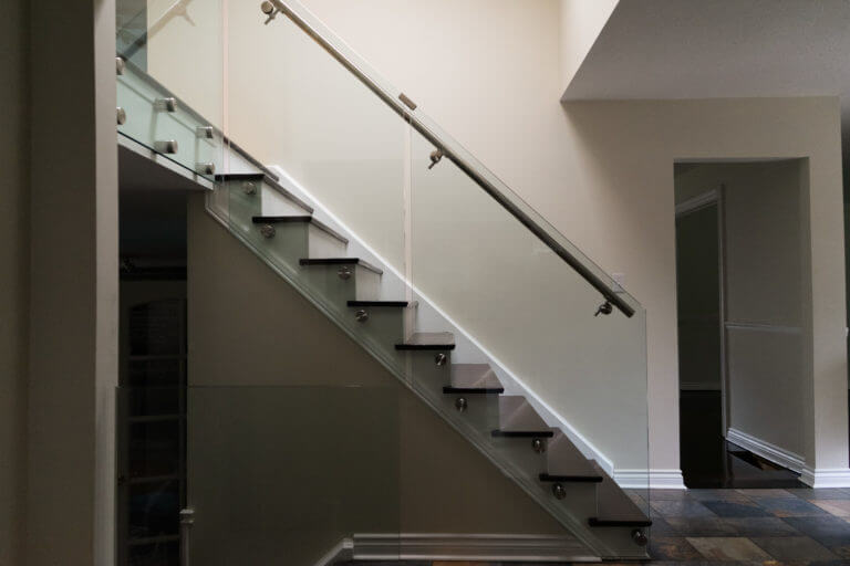 Glass railing for straight stairs with round metal handrails