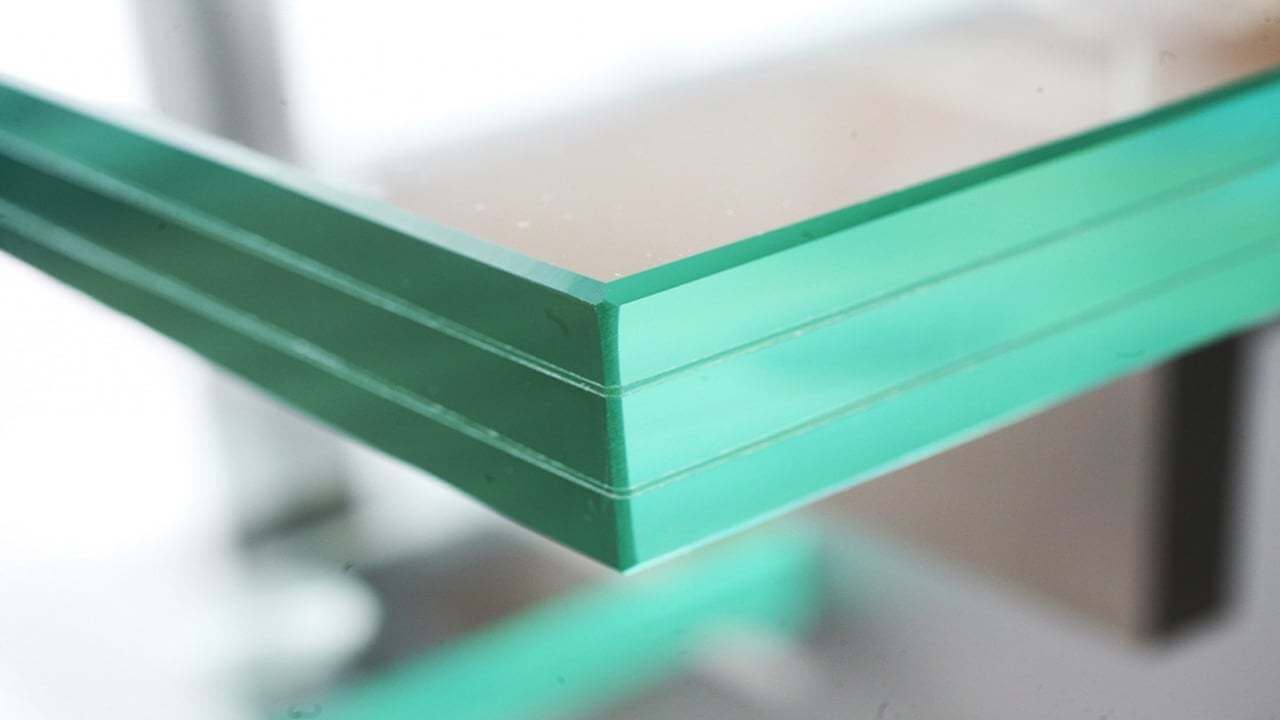 Tough triplex glass with a green tint
