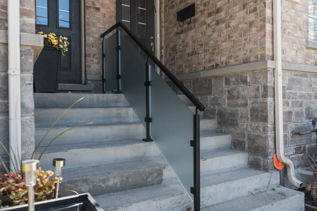 Stone staircase with frosted glass railings and square handrails - Post System