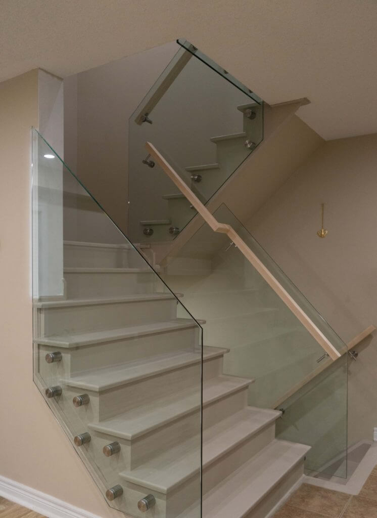 Glass railing installed using a pin system on a two-piece staircase