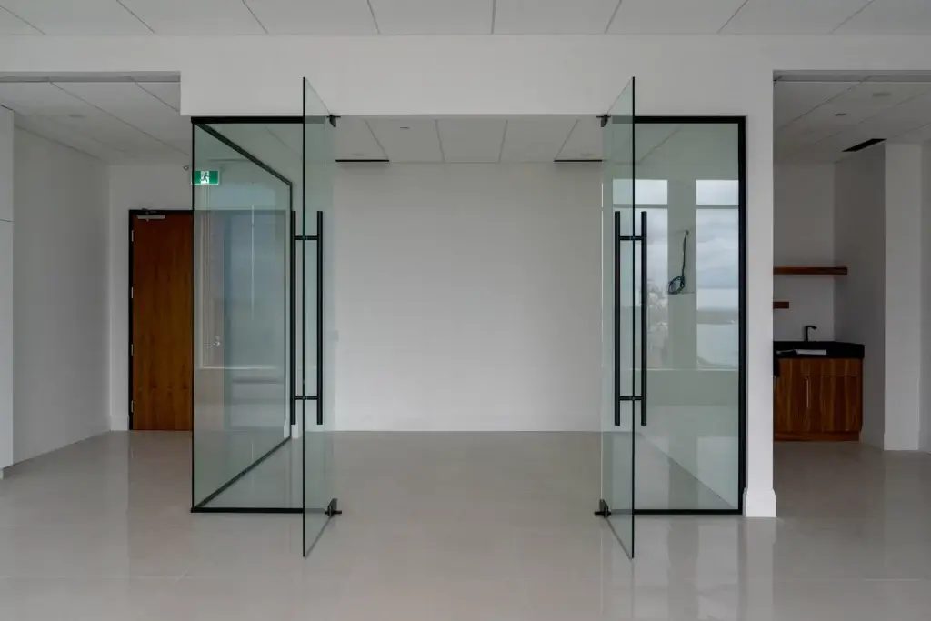 Glass office partition with two open glass doors. Patch System - Glass Office Partitions