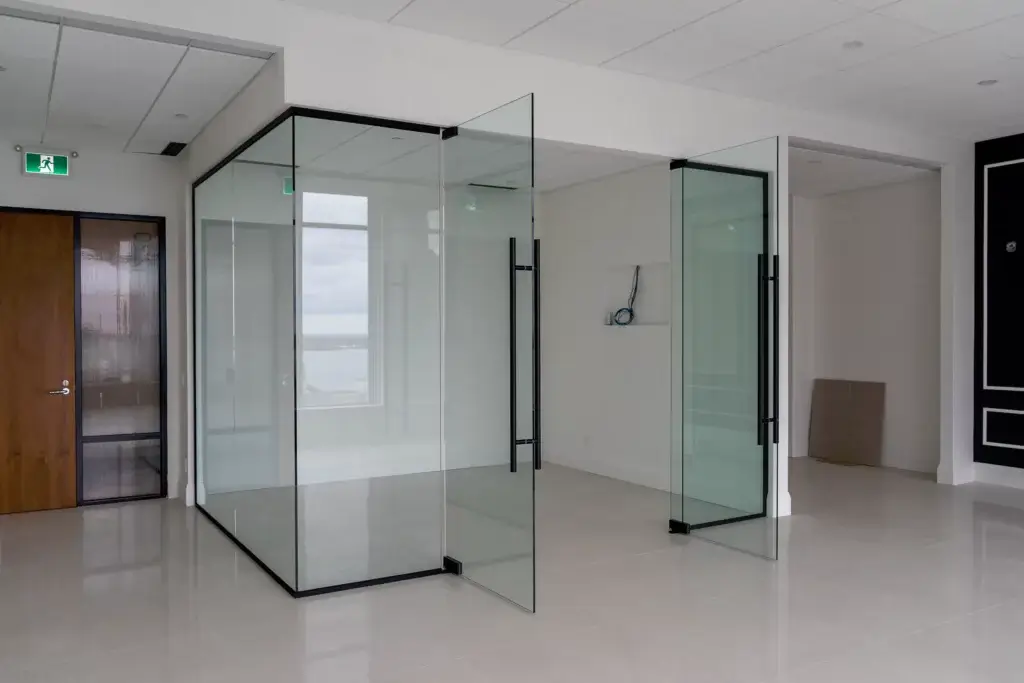 Glass office partition with two open glass doors. Patch System - Glass Office PartitionsSide. Side View